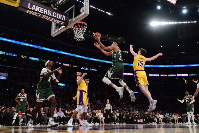 Feb 8, 2022; Los Angeles, California, USA; Milwaukee Bucks forward Giannis Antetokounmpo (34) moves to the basket ahead of Los Angeles Lakers guard Austin Reaves (15) during the second half at Crypto.com Arena. Mandatory Credit: Gary A. Vasquez-USA TODAY Sports
