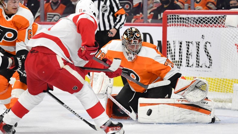 Feb 9, 2022; Philadelphia, Pennsylvania, USA; Philadelphia Flyers goaltender Carter Hart (79) makes a save against Detroit Red Wings right wing Filip Zadina (11) during the first period at Wells Fargo Center. Mandatory Credit: Eric Hartline-USA TODAY Sports