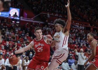 Feb 9, 2022; Piscataway, New Jersey, USA; Ohio State Buckeyes forward Kyle Young (25) dribbles against Rutgers Scarlet Knights forward Ron Harper Jr. (24) during the first half at Jersey Mike's Arena. Mandatory Credit: Vincent Carchietta-USA TODAY Sports
