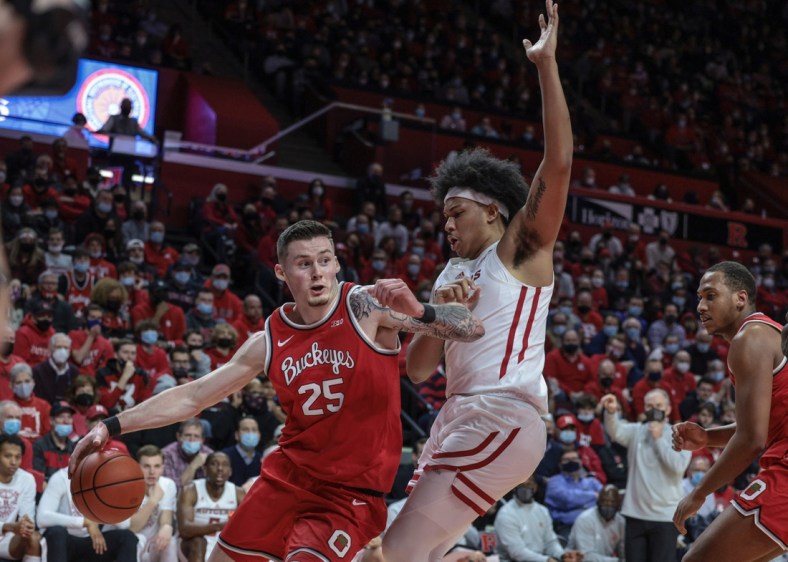 Feb 9, 2022; Piscataway, New Jersey, USA; Ohio State Buckeyes forward Kyle Young (25) dribbles against Rutgers Scarlet Knights forward Ron Harper Jr. (24) during the first half at Jersey Mike's Arena. Mandatory Credit: Vincent Carchietta-USA TODAY Sports