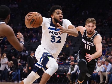 Feb 9, 2022; Sacramento, California, USA; Minnesota Timberwolves center Karl-Anthony Towns (32) drives in against Sacramento Kings center Domantas Sabonis (10) during the first quarter at Golden 1 Center. Mandatory Credit: Kelley L Cox-USA TODAY Sports