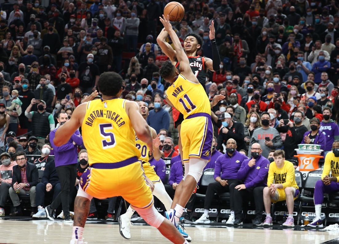 Portland Trail Blazers guard Anfernee Simons, second from left, shoots as  Los Angeles Lakers forward LeBron James defends during the first half of an  NBA basketball game Wednesday, Nov. 30, 2022, in