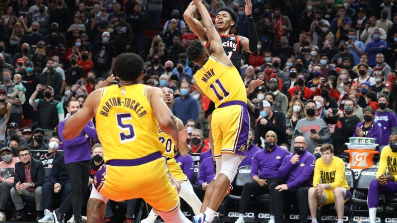 Feb 9, 2022; Portland, Oregon, USA;  Portland Trail Blazers guard Anfernee Simons (1) shoots over Los Angeles Lakers guard Malik Monk (11) in the second half at Moda Center. Mandatory Credit: Jaime Valdez-USA TODAY Sports