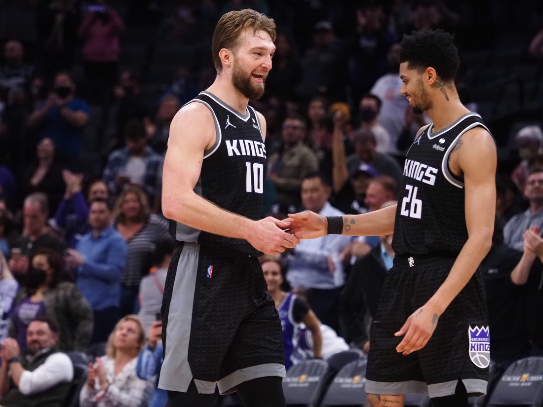 Feb 9, 2022; Sacramento, California, USA; Sacramento Kings center Domantas Sabonis (10) celebrates with guard Jeremy Lamb (26) in the final seconds of the game against the Minnesota Timberwolves during the fourth quarter at Golden 1 Center. Mandatory Credit: Kelley L Cox-USA TODAY Sports