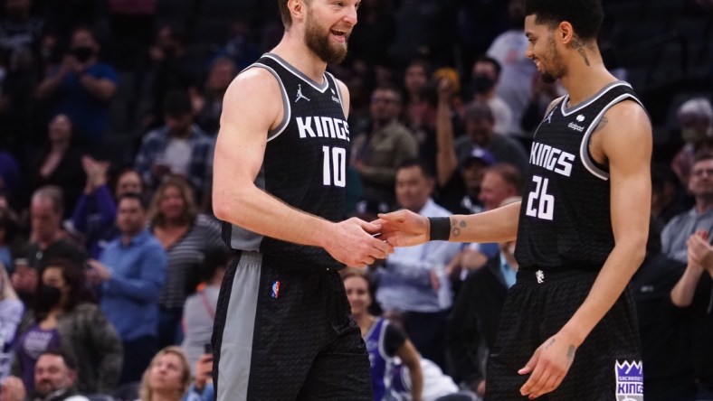 Feb 9, 2022; Sacramento, California, USA; Sacramento Kings center Domantas Sabonis (10) celebrates with guard Jeremy Lamb (26) in the final seconds of the game against the Minnesota Timberwolves during the fourth quarter at Golden 1 Center. Mandatory Credit: Kelley L Cox-USA TODAY Sports