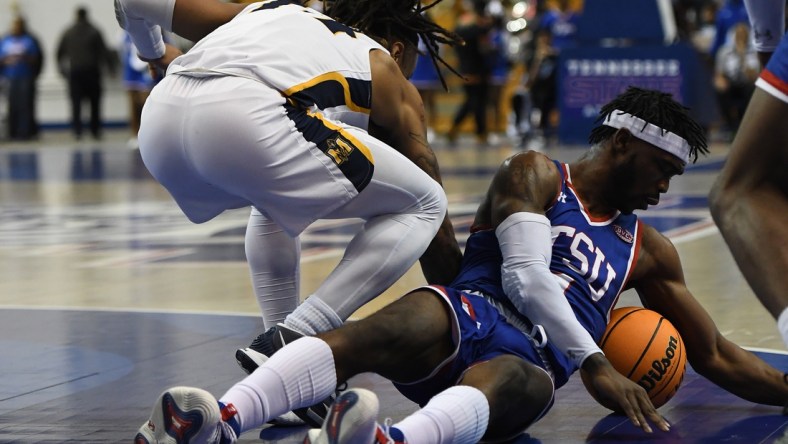 Feb 10, 2022; Nashville, Tennessee, USA; Tennessee State Tigers guard Marcus Fitzgerald Jr. (1) dives on the floor for a loose ball during the first half against the Murray State Racers at Gentry Complex. Mandatory Credit: Christopher Hanewinckel-USA TODAY Sports