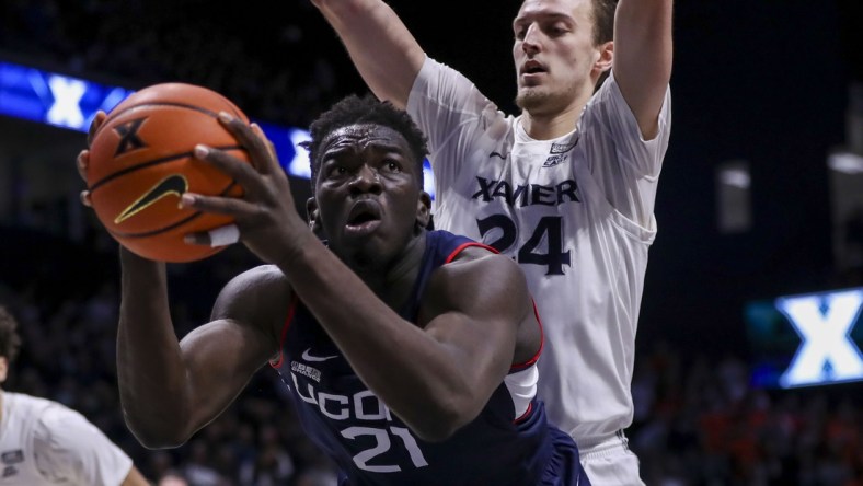 Feb 11, 2022; Cincinnati, Ohio, USA; Connecticut Huskies forward Adama Sanogo (21) controls the ball against Xavier Musketeers forward Jack Nunge (24) in the first half at Cintas Center. Mandatory Credit: Katie Stratman-USA TODAY Sports