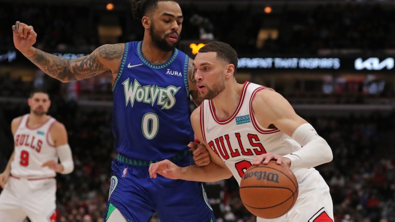 Feb 11, 2022; Chicago, Illinois, USA; Chicago Bulls guard Zach LaVine (8) drives around Minnesota Timberwolves guard D'Angelo Russell (0) during the first half at the United Center. Mandatory Credit: Dennis Wierzbicki-USA TODAY Sports