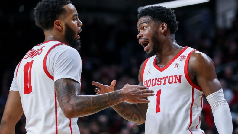 Feb 6, 2022; Cincinnati, Ohio, USA; Houston Cougars guard Kyler Edwards (11) reacts after a play with guard Jamal Shead (1) in the first half against the Cincinnati Bearcats at Fifth Third Arena. Mandatory Credit: Katie Stratman-USA TODAY Sports