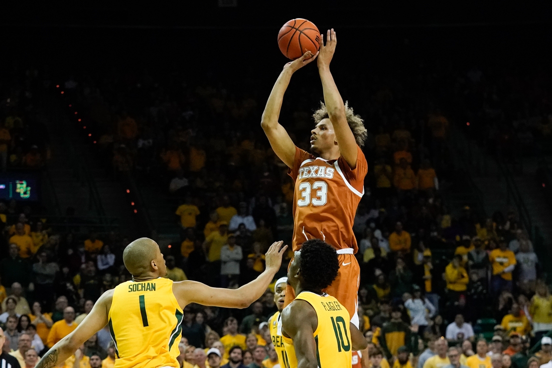 Feb 12, 2022; Waco, Texas, USA;  Texas Longhorns forward Tre Mitchell (33) shoots over Baylor Bears forward Jeremy Sochan (1) during the first half at Ferrell Center. Mandatory Credit: Chris Jones-USA TODAY Sports