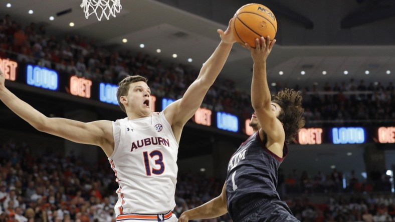 Feb 12, 2022; Auburn, Alabama, USA;  Texas A&M Aggies guard Marcus Williams (1) has his shot blocked by Auburn Tigers forward Walker Kessler (13) during the first half at Auburn Arena. Mandatory Credit: John Reed-USA TODAY Sports