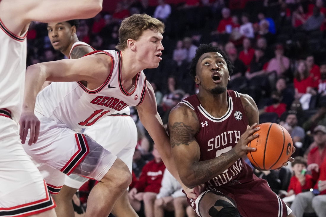 Feb 12, 2022; Athens, Georgia, USA; South Carolina Gamecocks guard Jermaine Couisnard (5) tries to get past Georgia Bulldogs forward Jaxon Etter (11) during the first half at Stegeman Coliseum. Mandatory Credit: Dale Zanine-USA TODAY Sports