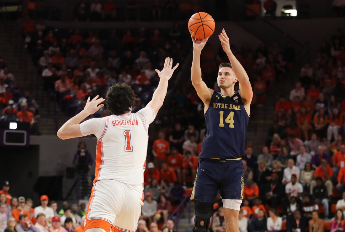 Feb 12, 2022; Clemson, South Carolina, USA; Notre Dame Fighting Irish forward Nate Laszewski (14) shoots the ball against Clemson Tigers forward Ian Schieffelin (1) during the first half at Littlejohn Coliseum. Mandatory Credit: Dawson Powers-USA TODAY Sports