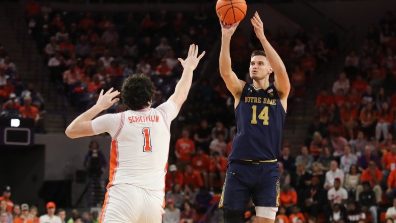 Feb 12, 2022; Clemson, South Carolina, USA; Notre Dame Fighting Irish forward Nate Laszewski (14) shoots the ball against Clemson Tigers forward Ian Schieffelin (1) during the first half at Littlejohn Coliseum. Mandatory Credit: Dawson Powers-USA TODAY Sports