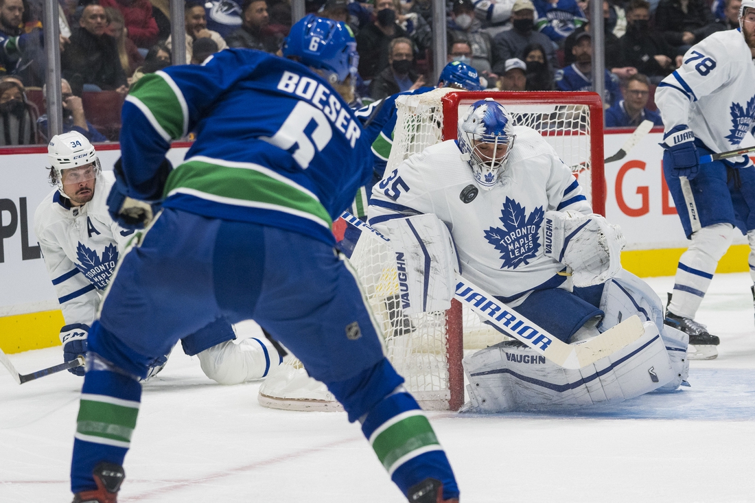 Feb 12, 2022; Vancouver, British Columbia, CAN; Toronto Maple Leafs goalie Petr Mrazek (35) makes a save against Vancouver Canucks forward Brock Boeser (6) in the first period at Rogers Arena. Mandatory Credit: Bob Frid-USA TODAY Sports