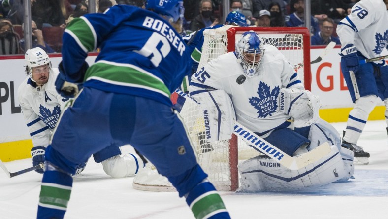 Feb 12, 2022; Vancouver, British Columbia, CAN; Toronto Maple Leafs goalie Petr Mrazek (35) makes a save against Vancouver Canucks forward Brock Boeser (6) in the first period at Rogers Arena. Mandatory Credit: Bob Frid-USA TODAY Sports