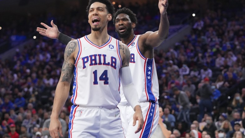 Feb 12, 2022; Philadelphia, Pennsylvania, USA; Philadelphia 76ers forward Danny Green (14) and center Joel Embiid (21) react after a foul called on Embiid against the Cleveland Cavaliers in the first half at the Wells Fargo Center. Mandatory Credit: Mitchell Leff-USA TODAY Sports