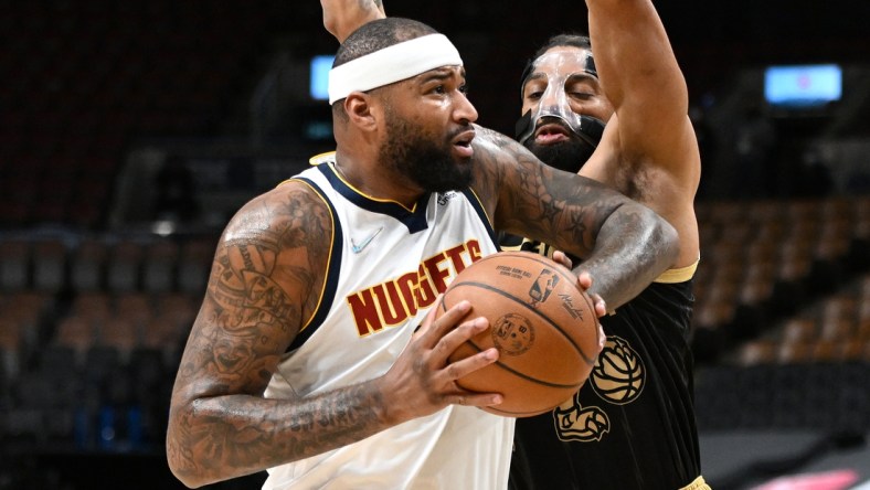 Feb 12, 2022; Toronto, Ontario, CAN;   Denver Nuggets center DeMarcus Cousins (4) drives against Toronto Raptors center Khem Birch (24) in the first half at Scotiabank Arena. Mandatory Credit: Dan Hamilton-USA TODAY Sports