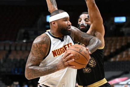 Feb 12, 2022; Toronto, Ontario, CAN;   Denver Nuggets center DeMarcus Cousins (4) drives against Toronto Raptors center Khem Birch (24) in the first half at Scotiabank Arena. Mandatory Credit: Dan Hamilton-USA TODAY Sports
