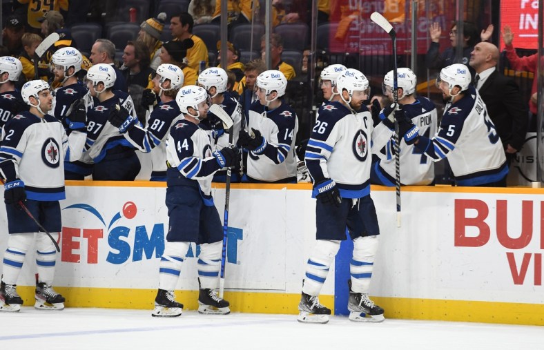 Feb 12, 2022; Nashville, Tennessee, USA; Winnipeg Jets right wing Blake Wheeler (26) celebrates with teammates after a goal against the Nashville Predators during the third period at Bridgestone Arena. Mandatory Credit: Christopher Hanewinckel-USA TODAY Sports