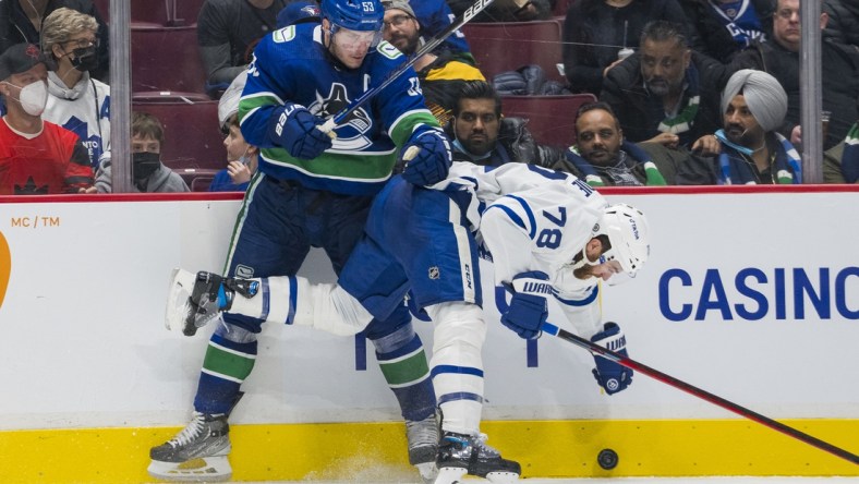 Feb 12, 2022; Vancouver, British Columbia, CAN; Vancouver Canucks forward Bo Horvat (53) checks Toronto Maple Leafs defenseman TJ Brodie (78) in the third period at Rogers Arena. Vancouver won 3-2. Mandatory Credit: Bob Frid-USA TODAY Sports