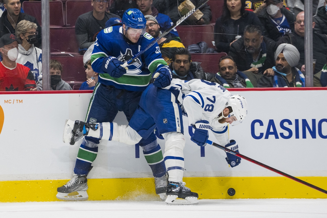 Feb 12, 2022; Vancouver, British Columbia, CAN; Vancouver Canucks forward Bo Horvat (53) checks Toronto Maple Leafs defenseman TJ Brodie (78) in the third period at Rogers Arena. Vancouver won 3-2. Mandatory Credit: Bob Frid-USA TODAY Sports