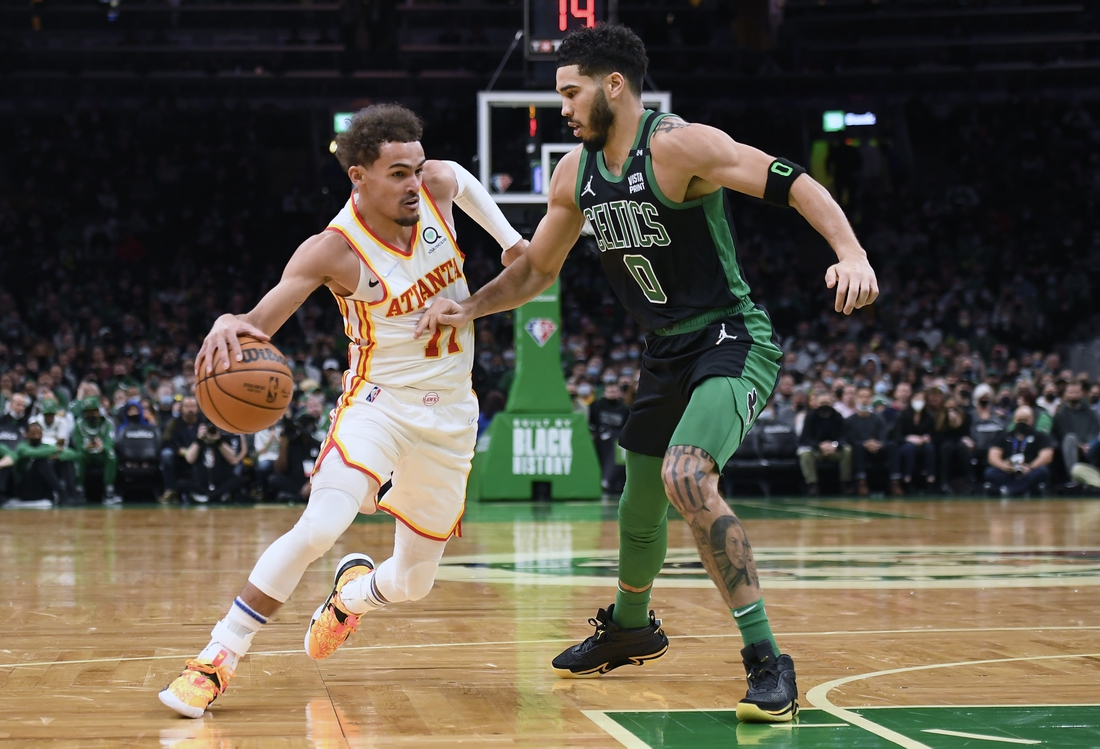 Feb 13, 2022; Boston, Massachusetts, USA;  Atlanta Hawks guard Trae Young (11) controls the ball while Boston Celtics forward Jayson Tatum (0) defends during the first half at TD Garden. Mandatory Credit: Bob DeChiara-USA TODAY Sports