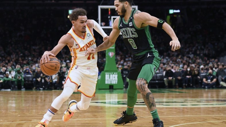 Feb 13, 2022; Boston, Massachusetts, USA;  Atlanta Hawks guard Trae Young (11) controls the ball while Boston Celtics forward Jayson Tatum (0) defends during the first half at TD Garden. Mandatory Credit: Bob DeChiara-USA TODAY Sports