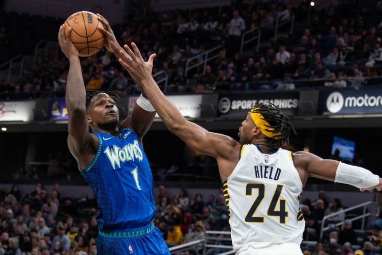 Feb 13, 2022; Indianapolis, Indiana, USA; Minnesota Timberwolves forward Anthony Edwards (1) shoots the ball while Indiana Pacers guard Buddy Hield (24) defends in the first half at Gainbridge Fieldhouse. Mandatory Credit: Trevor Ruszkowski-USA TODAY Sports