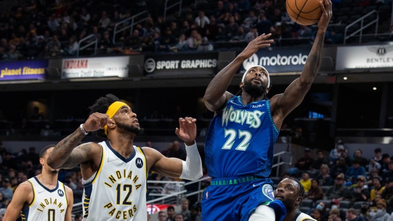 Feb 13, 2022; Indianapolis, Indiana, USA; Minnesota Timberwolves guard Patrick Beverley (22) shoots the ball while Indiana Pacers forward Oshae Brissett (12) defends in the first half at Gainbridge Fieldhouse. Mandatory Credit: Trevor Ruszkowski-USA TODAY Sports