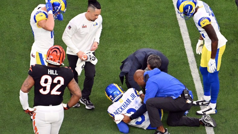 Feb 13, 2022; Inglewood, California, USA; Los Angeles Rams staff attend to wide receiver Odell Beckham Jr. (3) after a play in the second quarter against the Cincinnati Bengals in Super Bowl LVI at SoFi Stadium. Mandatory Credit: Richard Mackson-USA TODAY Sports