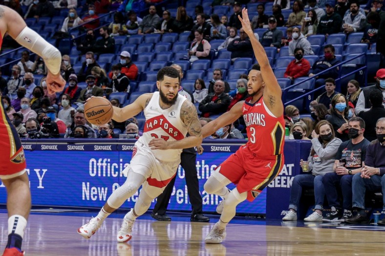 Feb 14, 2022; New Orleans, Louisiana, USA; Toronto Raptors guard Fred VanVleet (23) dribbles against  New Orleans Pelicans guard CJ McCollum (3) during the first half at the Smoothie King Center. Mandatory Credit: Stephen Lew-USA TODAY Sports