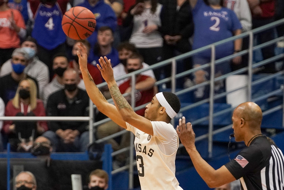 Feb 14, 2022; Lawrence, Kansas, USA; Kansas Jayhawks guard Dajuan Harris Jr. (3) shoots a three point shot against the Oklahoma State Cowboys during the first half at Allen Fieldhouse. Mandatory Credit: Denny Medley-USA TODAY Sports