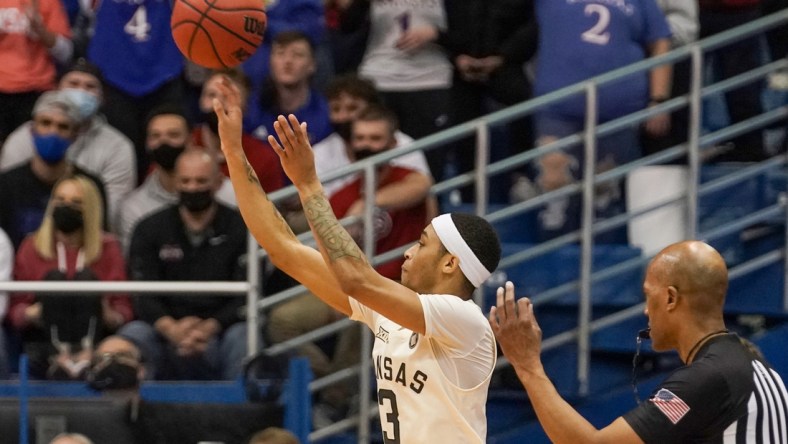 Feb 14, 2022; Lawrence, Kansas, USA; Kansas Jayhawks guard Dajuan Harris Jr. (3) shoots a three point shot against the Oklahoma State Cowboys during the first half at Allen Fieldhouse. Mandatory Credit: Denny Medley-USA TODAY Sports