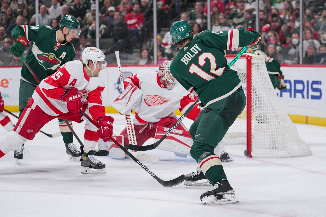 Feb 14, 2022; Saint Paul, Minnesota, USA; Minnesota Wild left wing Matt Boldy (12) scores his third goal against the Detroit Red Wings in the second period at Xcel Energy Center. Mandatory Credit: Brad Rempel-USA TODAY Sports