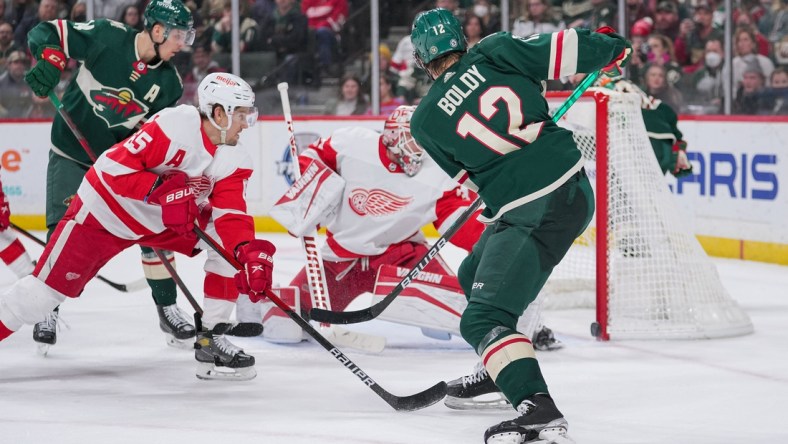 Feb 14, 2022; Saint Paul, Minnesota, USA; Minnesota Wild left wing Matt Boldy (12) scores his third goal against the Detroit Red Wings in the second period at Xcel Energy Center. Mandatory Credit: Brad Rempel-USA TODAY Sports