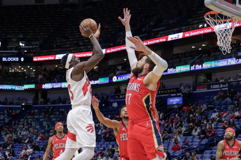 Feb 14, 2022; New Orleans, Louisiana, USA; Toronto Raptors forward Pascal Siakam (43) shoots a jump shot over New Orleans Pelicans center Jonas Valanciunas (17) during the first half at the Smoothie King Center. Mandatory Credit: Stephen Lew-USA TODAY Sports