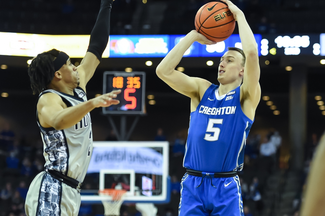 Feb 14, 2022; Omaha, Nebraska, USA; Creighton Bluejays guard Alex O'Connell (5) attempts a three point shot against Georgetown Hoyas guard Dante Harris (2) in the second half at CHI Health Center Omaha. Mandatory Credit: Steven Branscombe-USA TODAY Sports