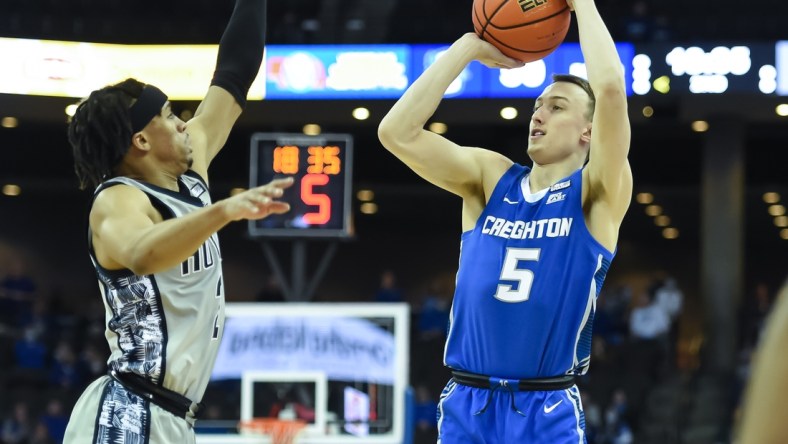 Feb 14, 2022; Omaha, Nebraska, USA; Creighton Bluejays guard Alex O'Connell (5) attempts a three point shot against Georgetown Hoyas guard Dante Harris (2) in the second half at CHI Health Center Omaha. Mandatory Credit: Steven Branscombe-USA TODAY Sports