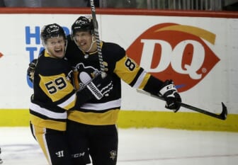 Feb 15, 2022; Pittsburgh, Pennsylvania, USA;  Pittsburgh Penguins left wing Jake Guentzel (59) congratulates center Sidney Crosby (87) after Crosby scored his 500th career NHL goal against the Philadelphia Flyers during the first period at PPG Paints Arena. Mandatory Credit: Charles LeClaire-USA TODAY Sports