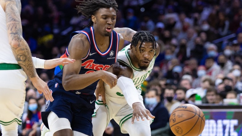 Feb 15, 2022; Philadelphia, Pennsylvania, USA; Philadelphia 76ers guard Tyrese Maxey (0) and Boston Celtics guard Marcus Smart (36) chase a loose ball during the first quarter at Wells Fargo Center. Mandatory Credit: Bill Streicher-USA TODAY Sports