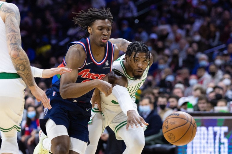 Feb 15, 2022; Philadelphia, Pennsylvania, USA; Philadelphia 76ers guard Tyrese Maxey (0) and Boston Celtics guard Marcus Smart (36) chase a loose ball during the first quarter at Wells Fargo Center. Mandatory Credit: Bill Streicher-USA TODAY Sports