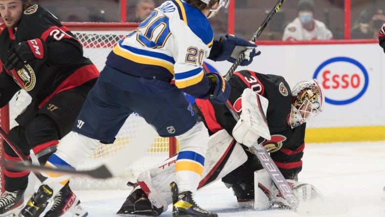 Feb 15, 2022; Ottawa, Ontario, CAN; Ottawa Senators goalie Matt Murray (30) makes a save in front of St. Louis Blues left wing Brandon Saad (20) in the first period at the Canadian Tire Centre. Mandatory Credit: Marc DesRosiers-USA TODAY Sports