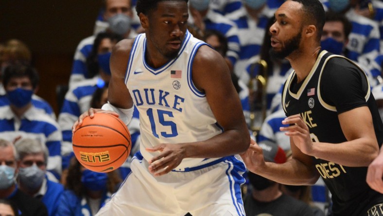 Feb 15, 2022; Durham, North Carolina, USA; Duke Blue Devils center Mark Williams (15) moves the ball against Wake Forest Demon Deacons forward Dallas Walton (13) during the first half at Cameron Indoor Stadium. Mandatory Credit: Rob Kinnan-USA TODAY Sports