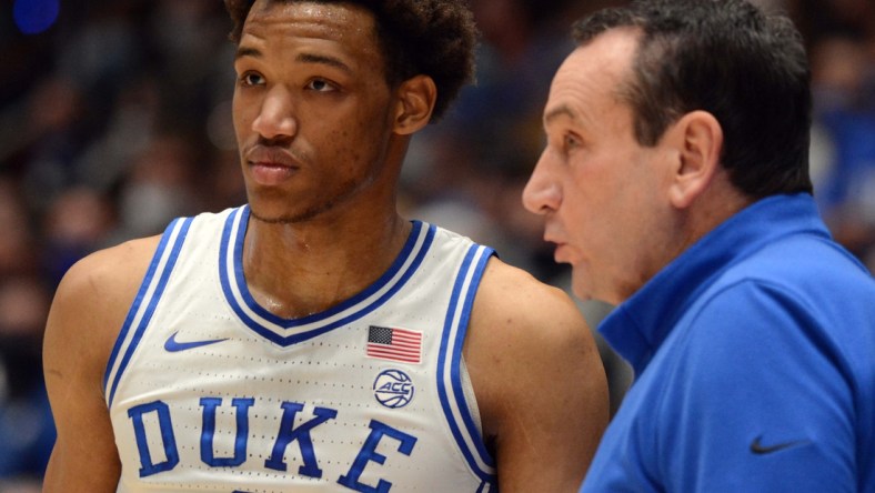 Feb 15, 2022; Durham, North Carolina, USA; Duke Blue Devils head coach Mike Krzyzewski (right) give instructions to  forward Wendell Moore Jr. (0) during the first half against the Wake Forest Demon Deacons at Cameron Indoor Stadium. Mandatory Credit: Rob Kinnan-USA TODAY Sports