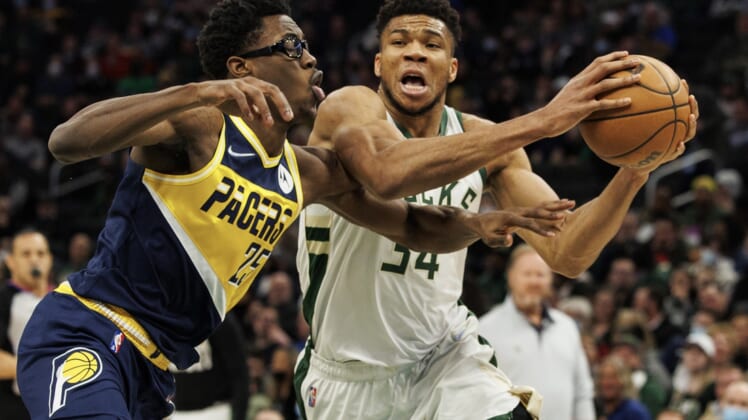 Feb 15, 2022; Milwaukee, Wisconsin, USA;  Milwaukee Bucks forward Giannis Antetokounmpo (34) drives for the basket against Indiana Pacers forward Jalen Smith (25) during the first quarter at Fiserv Forum. Mandatory Credit: Jeff Hanisch-USA TODAY Sports