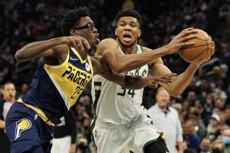 Feb 15, 2022; Milwaukee, Wisconsin, USA;  Milwaukee Bucks forward Giannis Antetokounmpo (34) drives for the basket against Indiana Pacers forward Jalen Smith (25) during the first quarter at Fiserv Forum. Mandatory Credit: Jeff Hanisch-USA TODAY Sports