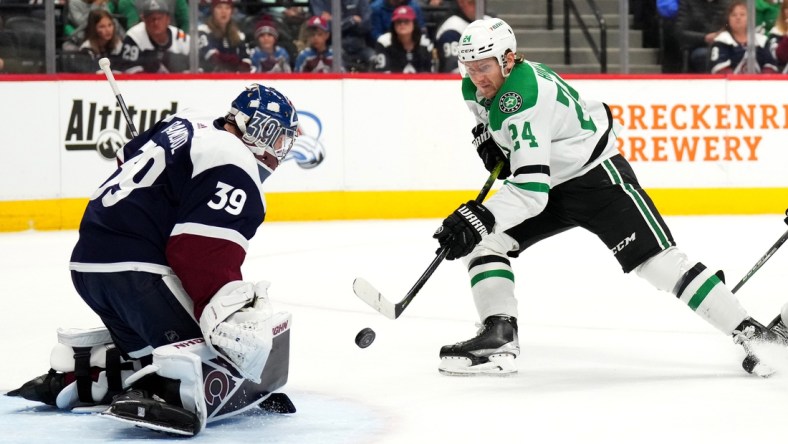 Feb 15, 2022; Denver, Colorado, USA; Dallas Stars center Roope Hintz (24) shoots the puck at Colorado Avalanche goaltender Pavel Francouz (39) in the first period at Ball Arena. Mandatory Credit: Ron Chenoy-USA TODAY Sports