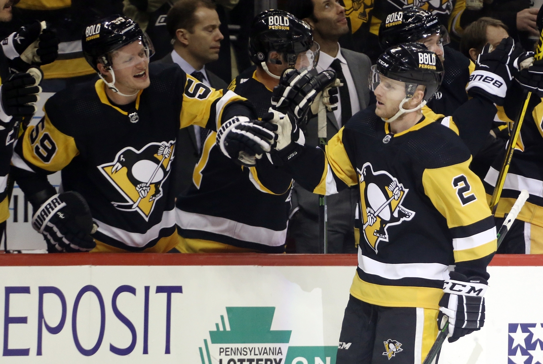 Feb 15, 2022; Pittsburgh, Pennsylvania, USA;  Pittsburgh Penguins defenseman Chad Ruhwedel (2) celebrates his goal with the Pens bench against the Philadelphia Flyers during the third period at PPG Paints Arena. The Penguins won 5-4 in overtime. Mandatory Credit: Charles LeClaire-USA TODAY Sports