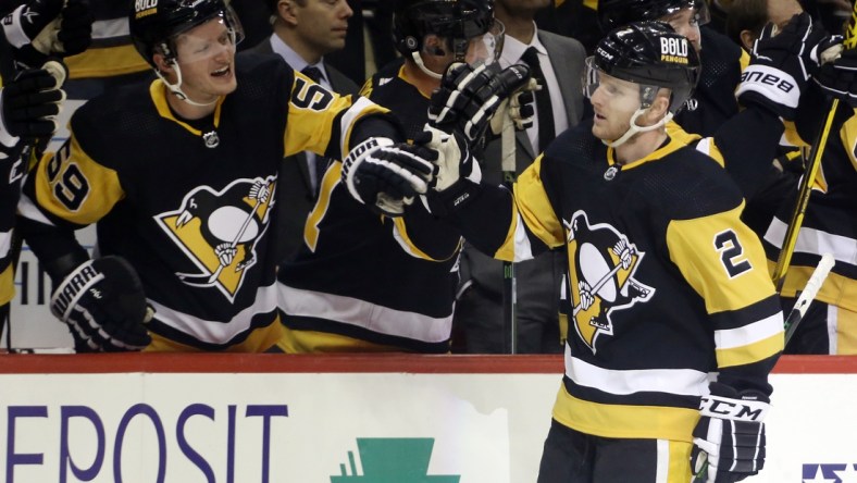 Feb 15, 2022; Pittsburgh, Pennsylvania, USA;  Pittsburgh Penguins defenseman Chad Ruhwedel (2) celebrates his goal with the Pens bench against the Philadelphia Flyers during the third period at PPG Paints Arena. The Penguins won 5-4 in overtime. Mandatory Credit: Charles LeClaire-USA TODAY Sports